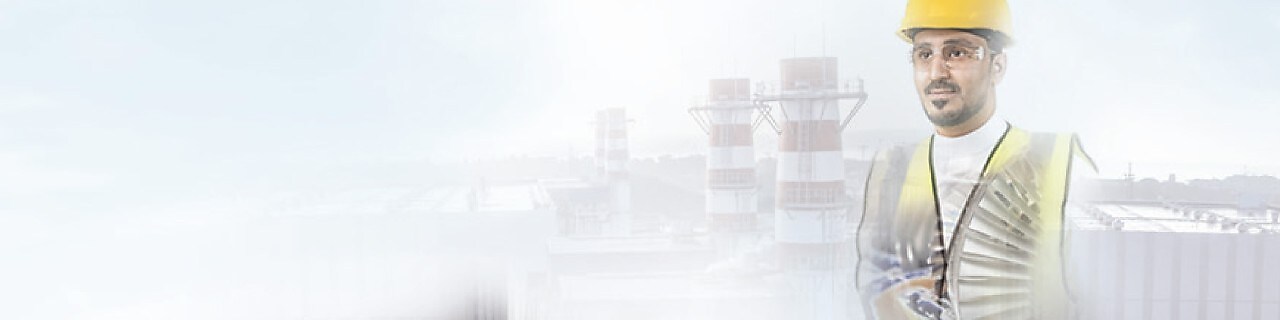 worker in a yellow hard hat transposed onto a background of a power plant