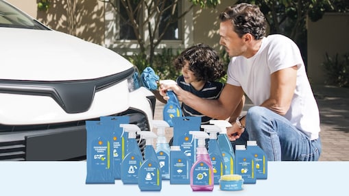 Man and a child cleaning a car with Shell Car Care