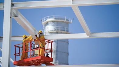 Two engineers on crane doing maintenance work