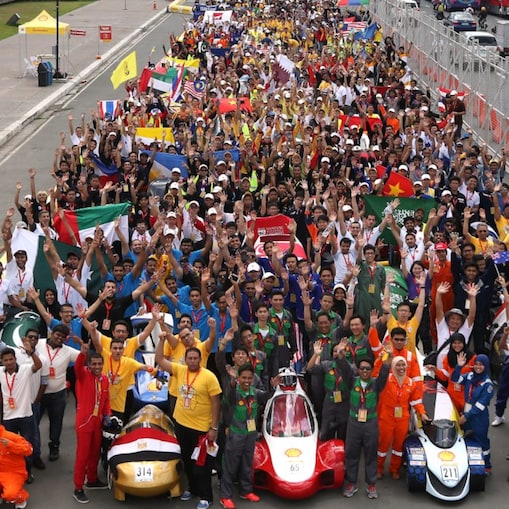 Participants pose with their vehicles during day one of the Shell Eco-marathon in Manila
