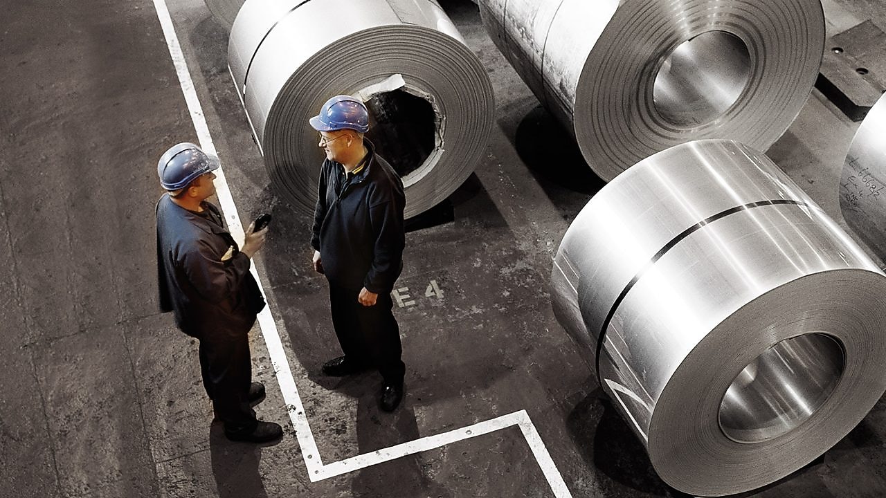 two workers in a metal factory