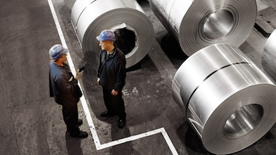two workers in a metal factory