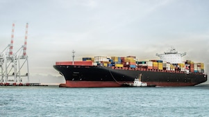 large tanker at sea loaded with container crates