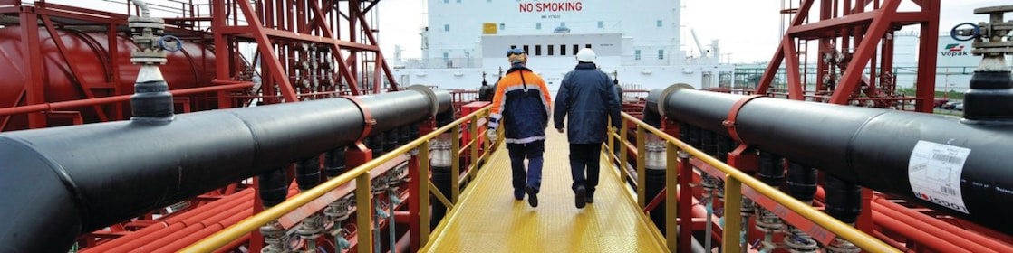 Shell employee walking along on a tanker 