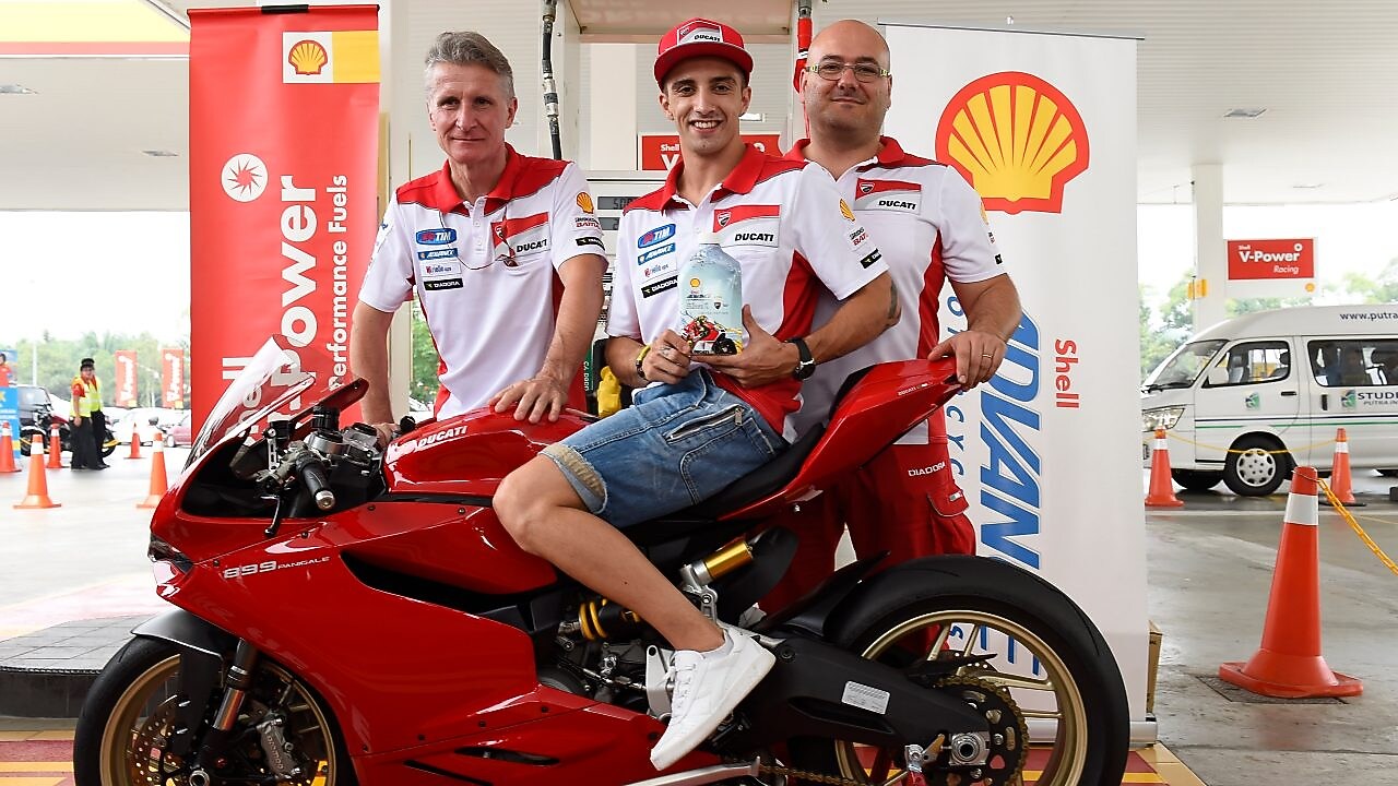 Ducati superbike with seated rider and tech team
