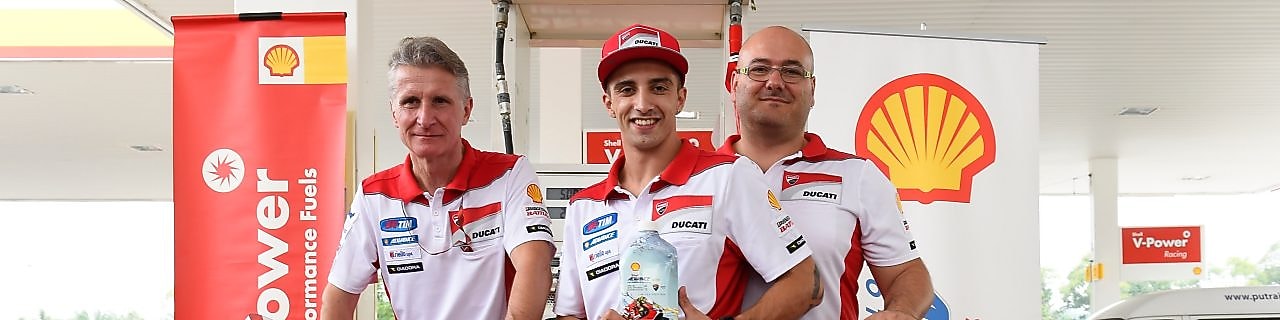 Ducati superbike with seated rider and tech team