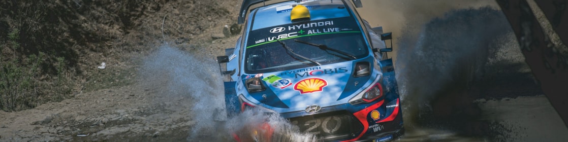 An Hyundai Shell World Rally Team car racing through a forest